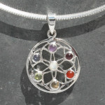 sterling silver Chakra Flower, Seed of Life Pendant contains a corresponding stone for each of the seven Chakras, starting at the Crown with Rainbow Moonstone (centre of the Seed of Life) followed by: Amethyst, Iolite, Peridot, Citrine, Carnelian and Garnet at the Root Chakra.